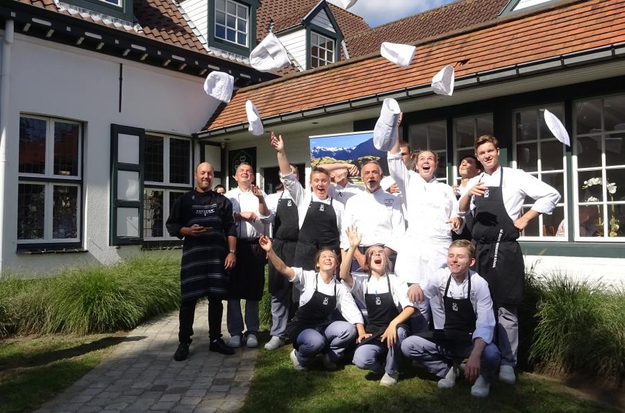 Trainee Belgian chefs celebrate what they have learned about NZ venison from NZ chefs Graham Brown (centre) and Shannon Campbell (far left)