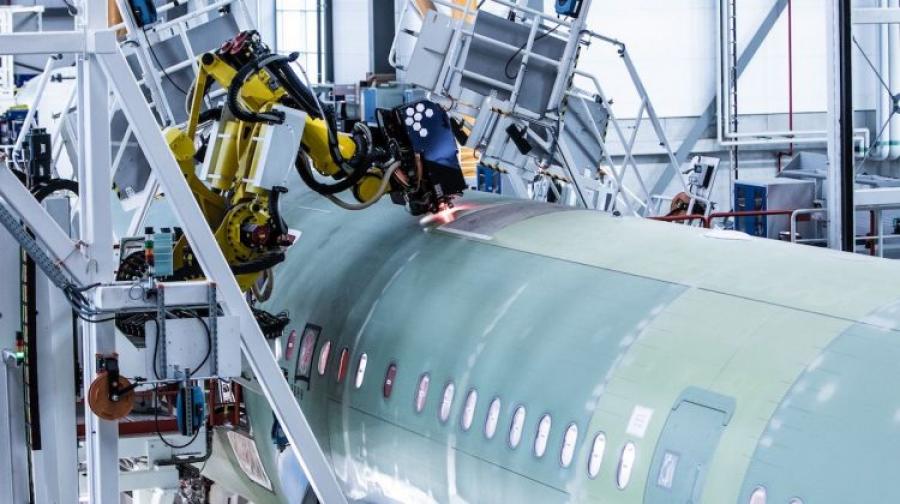 Airbus’ newest final assembly line in Hamburg, includes two seven-axis robotic arms that perform precise fuselage drilling. (Airbus)