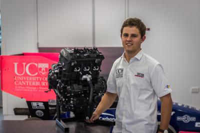 UC Motorsport team principal Jacob Ewing with one of the Triumph Daytona 675R engines that the students will be using to build their Formula Student race car.   